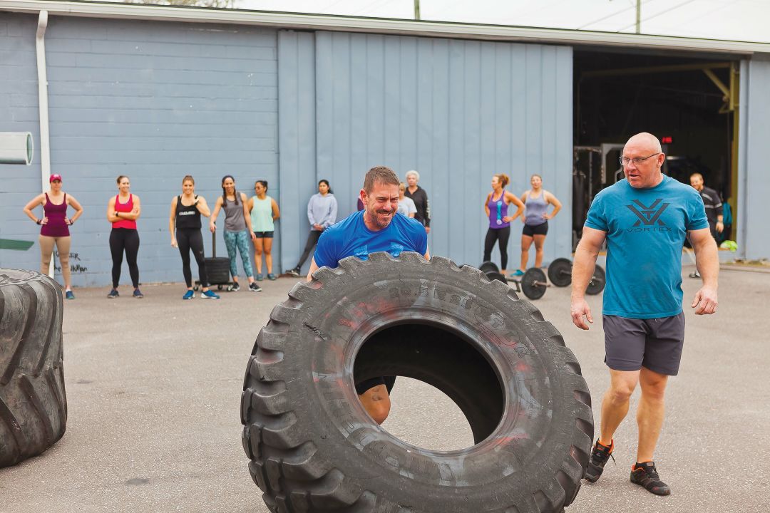 Brandon Powell (left) and Rob Scholl prepare for the World’s Strongest Manatee competition.