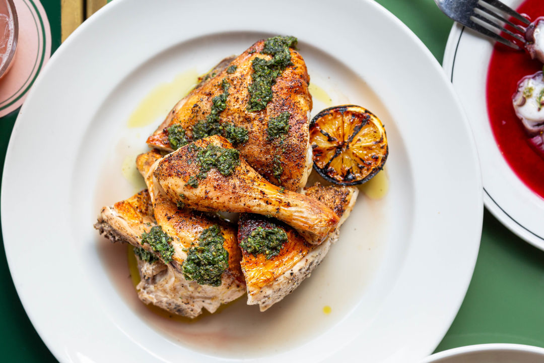a plate of roasted chicken with salsa verde.