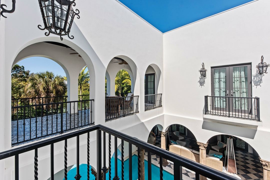 Surrounding balconies and a breezeway create a communal pool piazza.