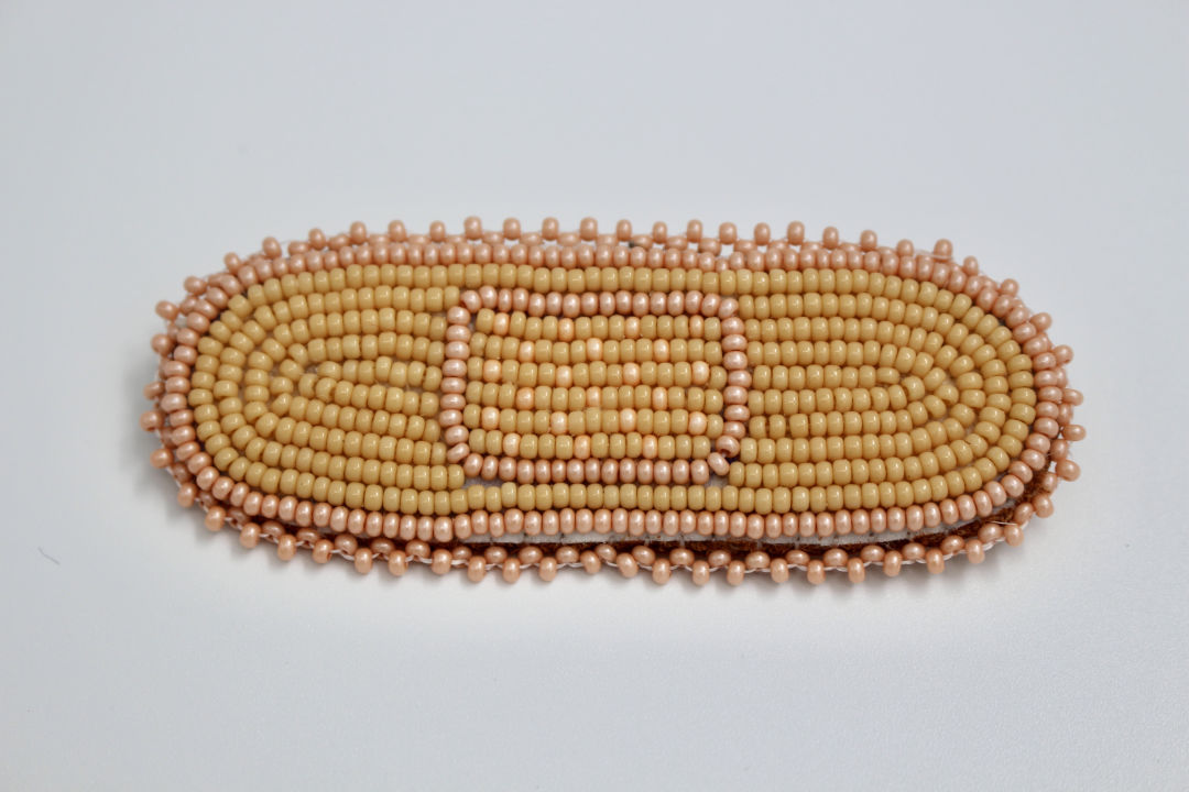 Corinne Zepeda (Seminole/Mexican, b. 1997), For Your Trauma, 2020. Seed beads on leather with pin attachment, 3 × 1 in. Courtesy of the artist.