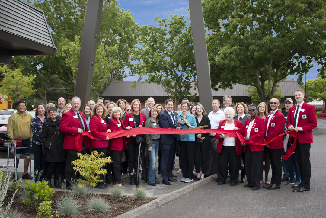 People gathered for a ribbon-cutting ceremony