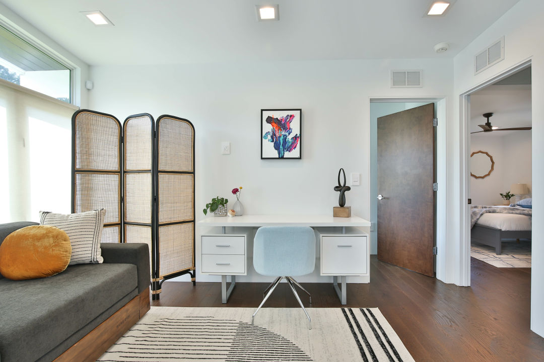 A stylish work desk area in a living room.