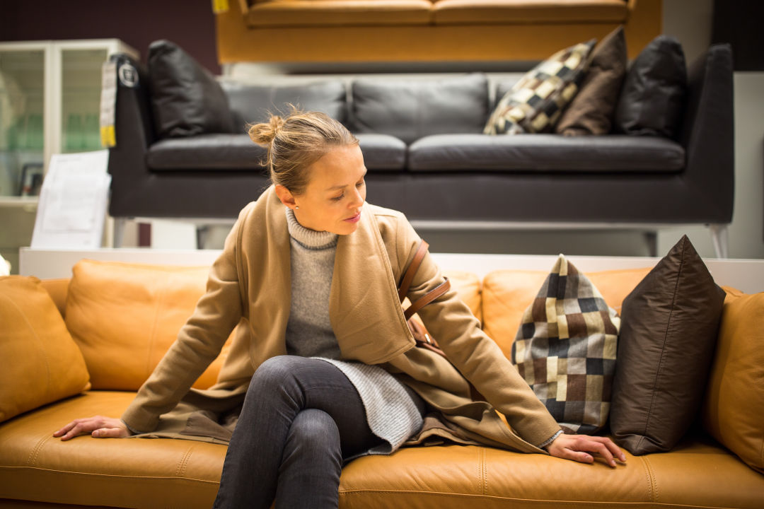 A woman shops for furniture.