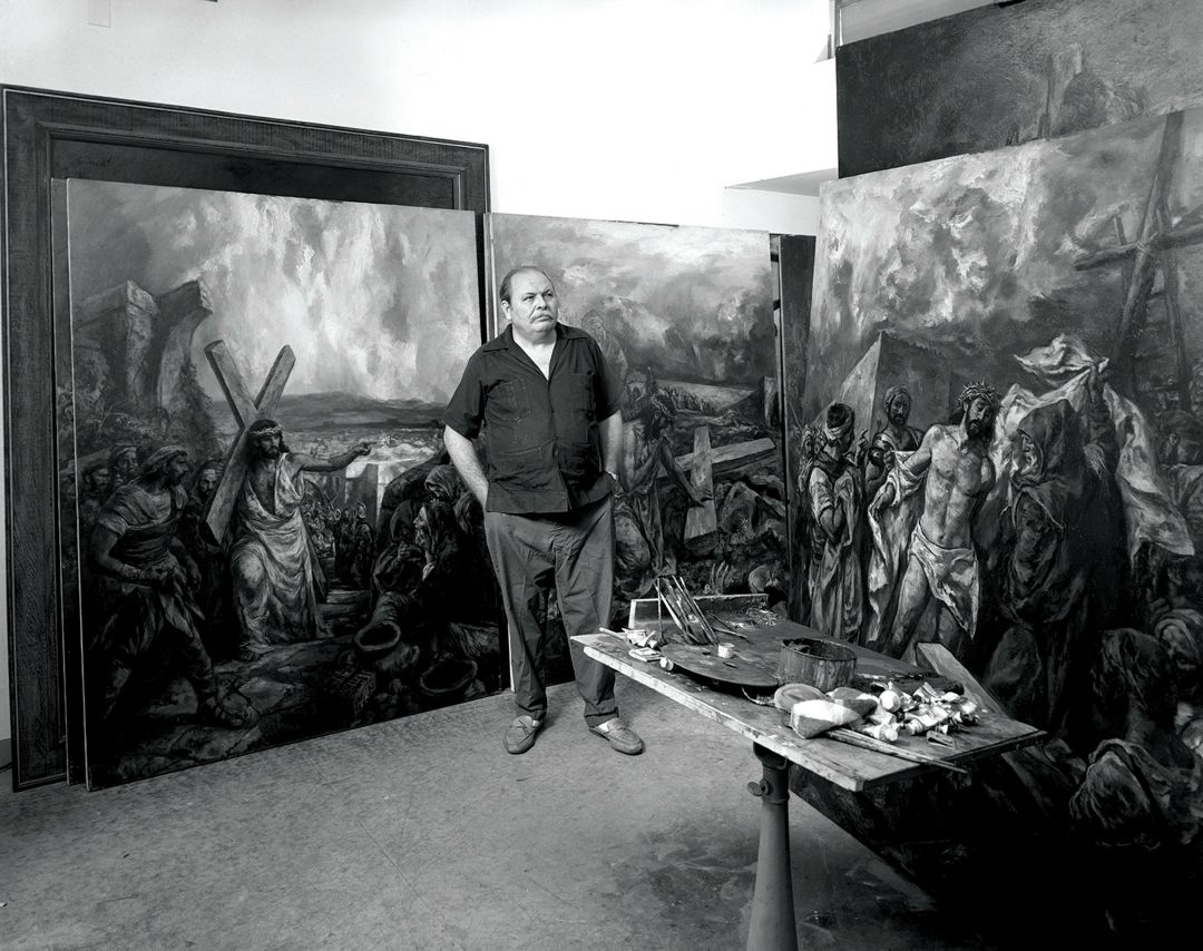 Ben in his studio, with the stations of the cross paintings.