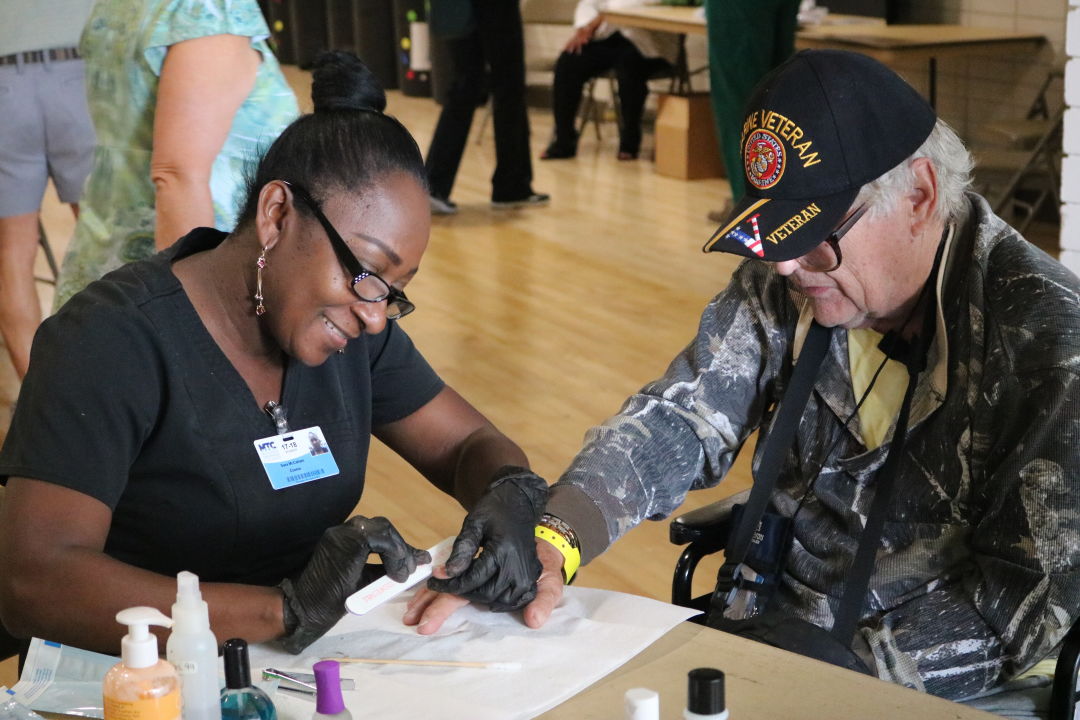 A homeless veteran receives assistance at a past Stand Down event.