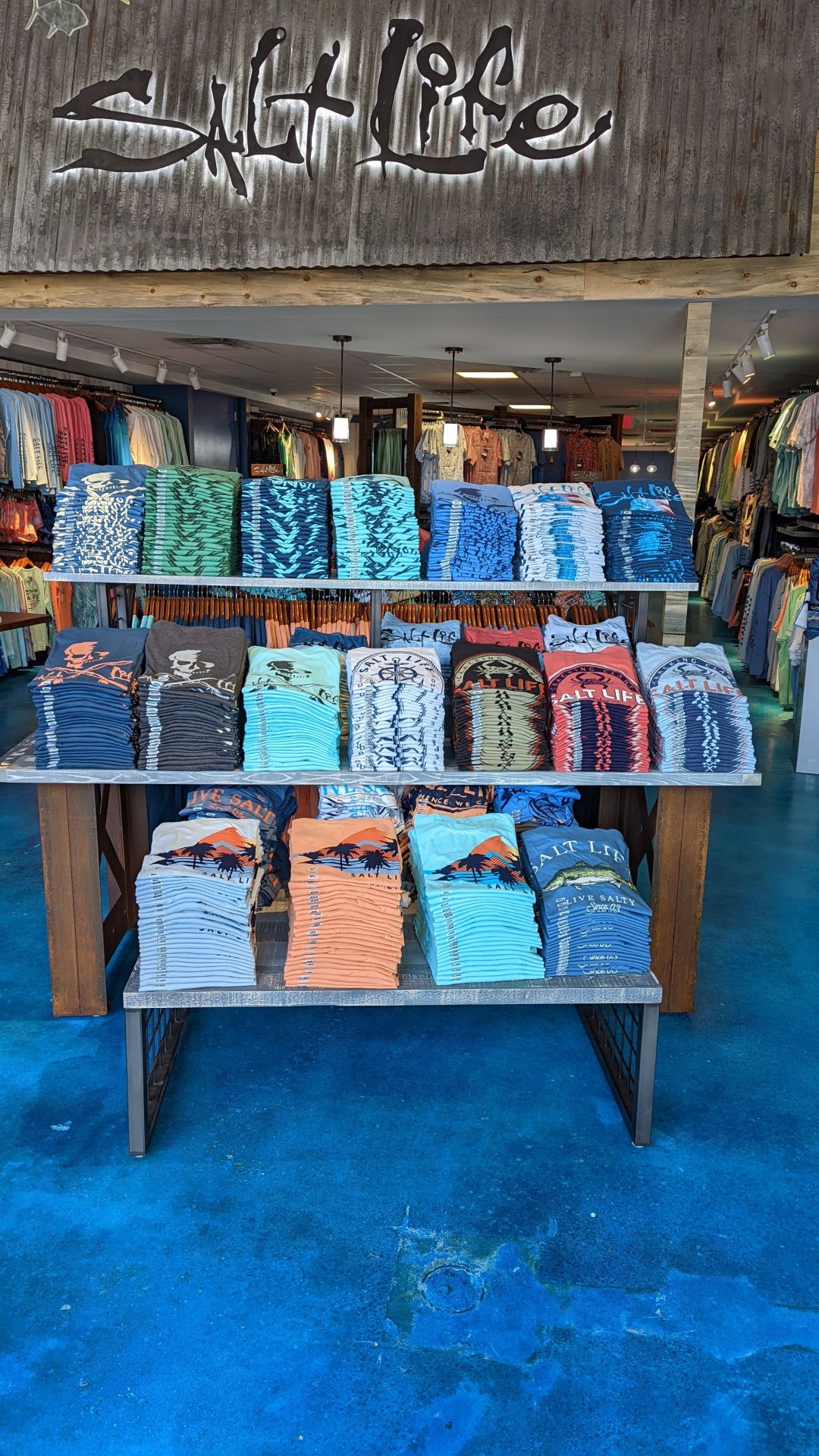 Picture of a display with Salt Life shirts and sign.