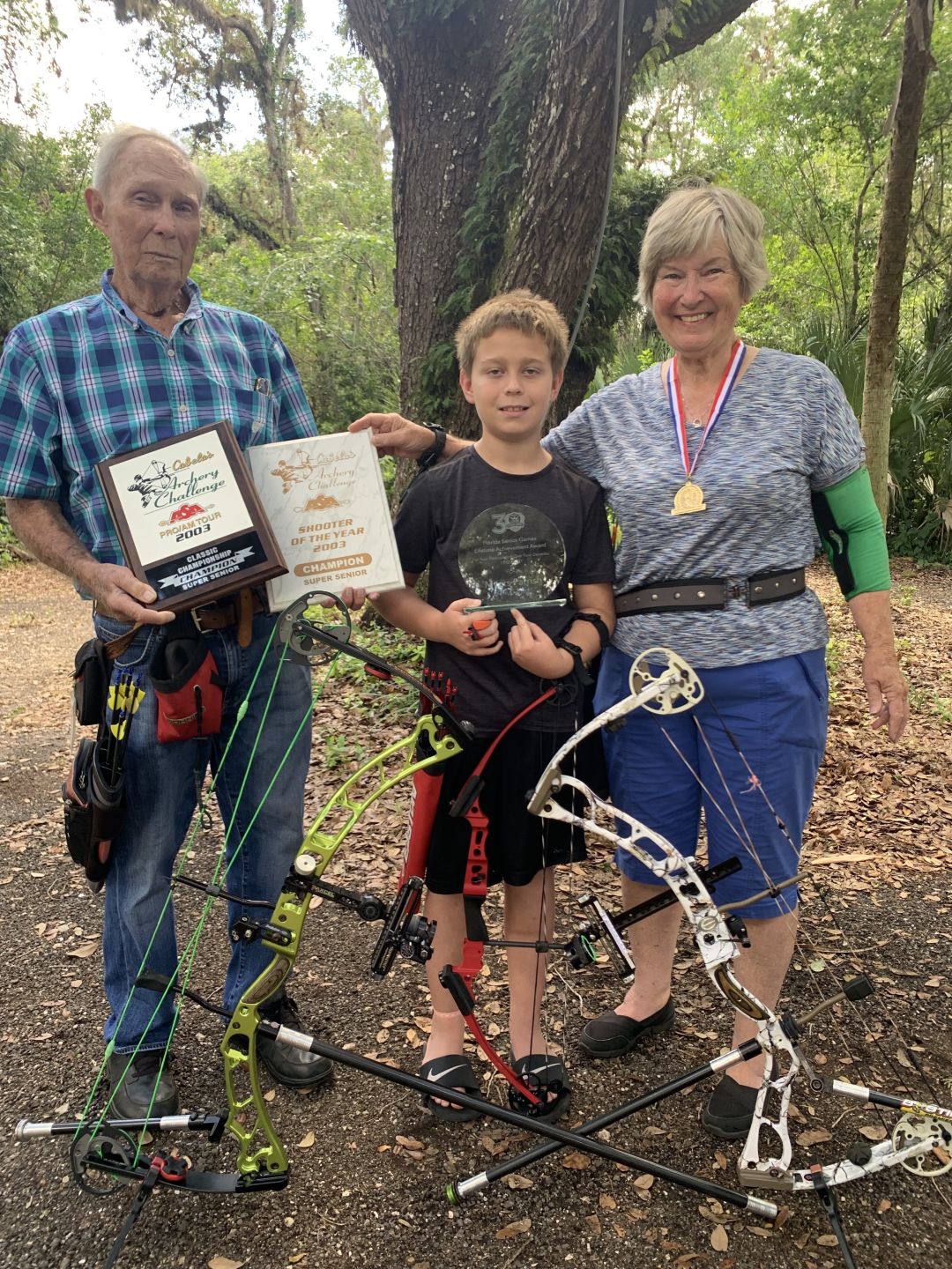 Myers, Roscoe and Alice posing with Myers' Lifetime Achievement award.