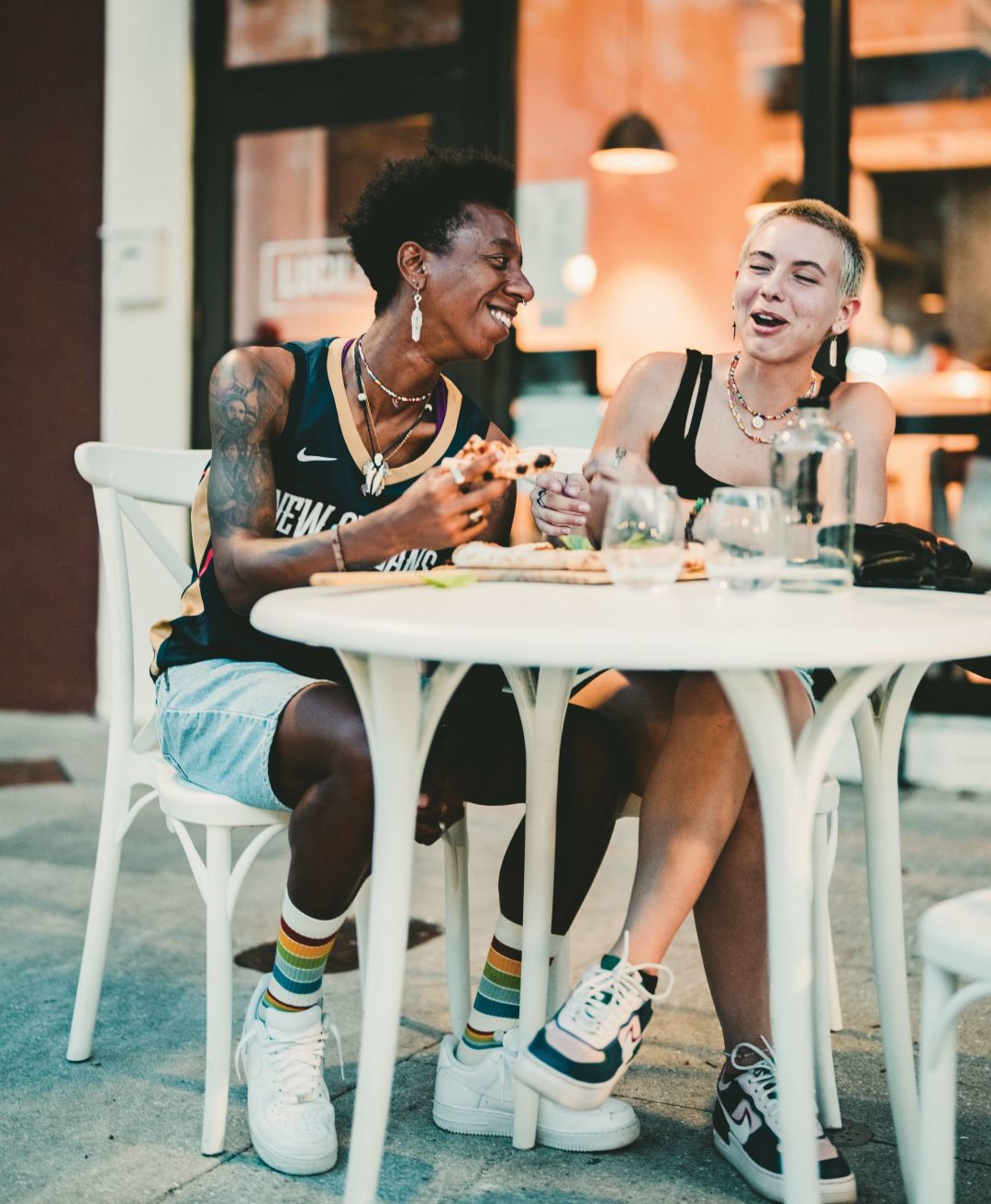 Diners enjoying a vegan pizza at Lucile.