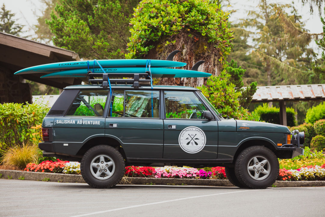 Jeep Rover with stand-up paddleboards on roof