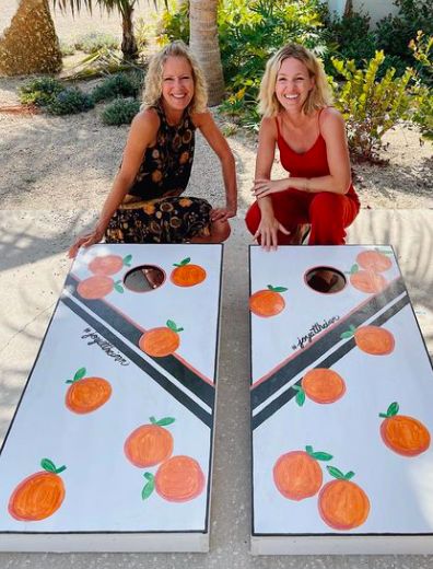 Ashley and her mom show off their DIY corn hole.