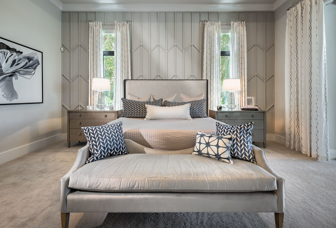 A headboard wall stands out with a custom wall panel design.