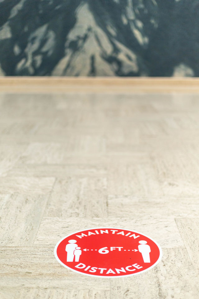 Sticker on the floor of the Portland Art Museum directs visitors to maintain a 6-foot distance from others