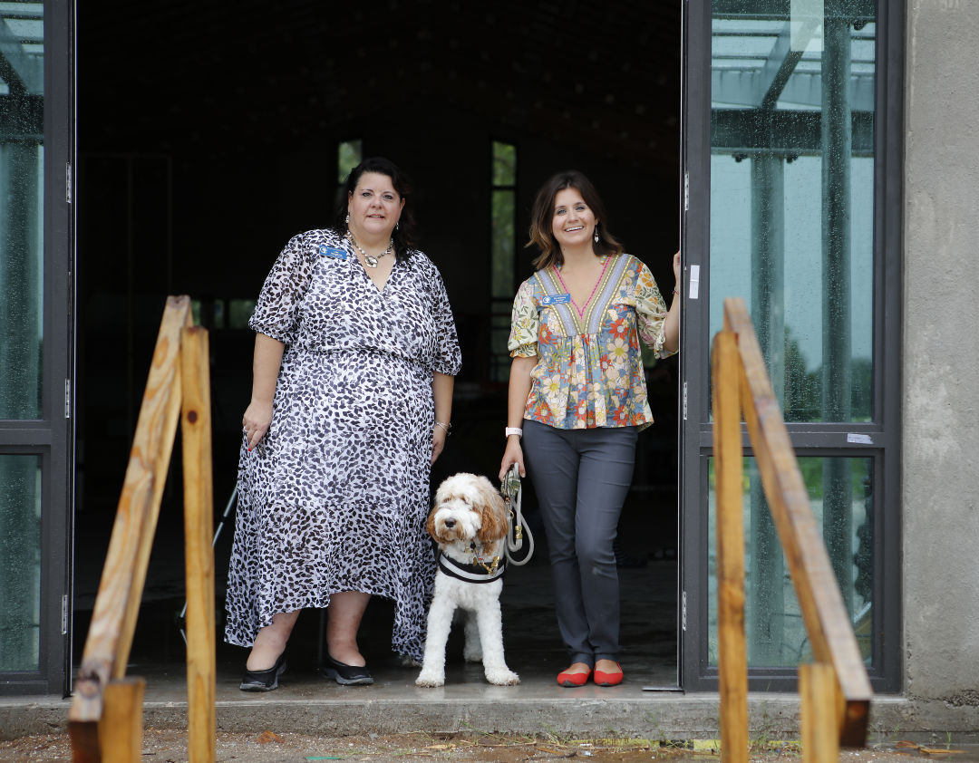 Resilient Retreat executive director Lisa Intagliata, left, with therapy dog Journey and Resilient Retreat board chair and founder Dr. Sidney Turner (right).