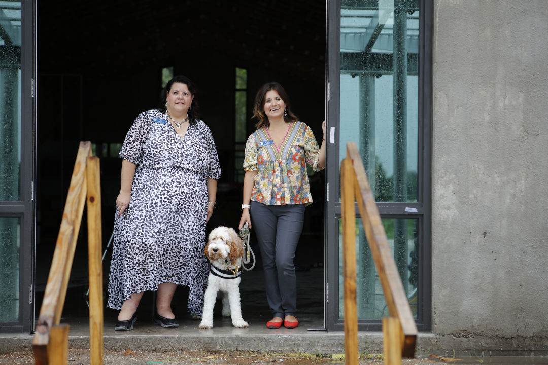 Resilient Retreat executive director Lisa Intagliata, left, with therapy dog Journey and Resilient Retreat board chair and founder Dr. Sidney Turner (right).