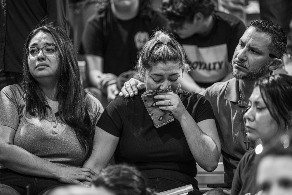 A family grieving at the town vigil