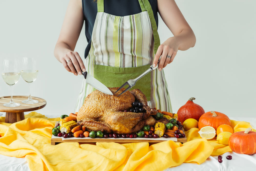 Someone cutting a Thanksgiving turkey
