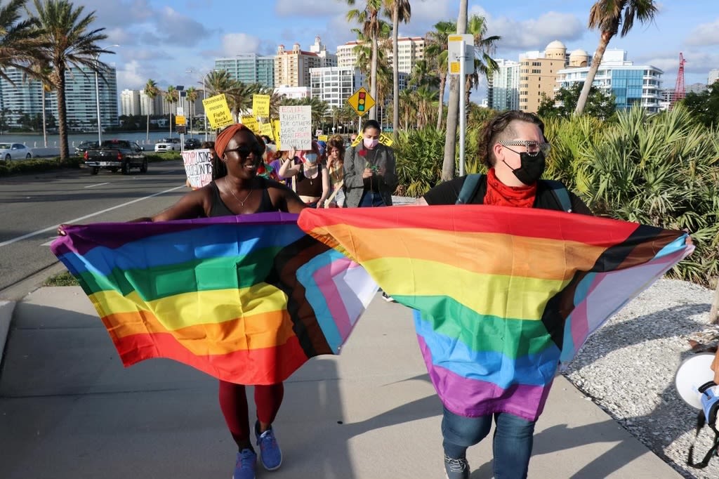 Grace Korley (left) and Shannon Fortner (right) marching the Ringling Bridge in honor of Pulse nightclub victims and the lighting of the bridge for Pride Month.