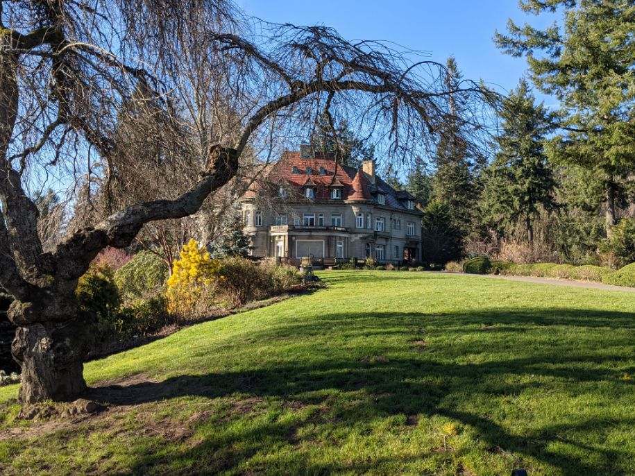 A grand home on a grassy hill