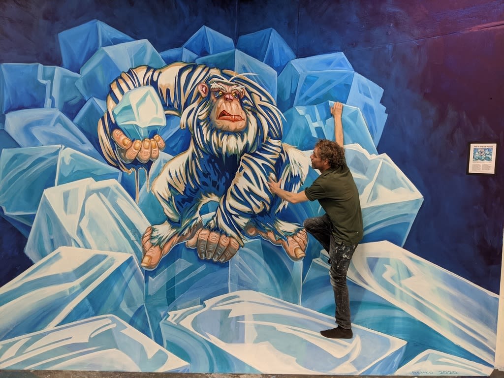 Man interacts with 3D illusion chalk painting.