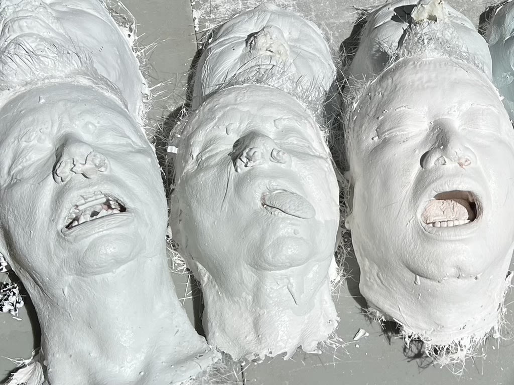 Zombie heads, cast from members of the Sarasota community, wait to be painted.