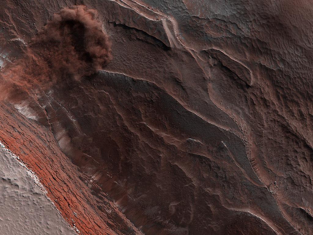 Hi-RISE, the High-Resolution Imaging Science Experiment camera aboard NASA's Mars Reconnaissance Orbiter (MRO), captured this avalanche plunging down a 1,640-foot-tall cliff in 2019.