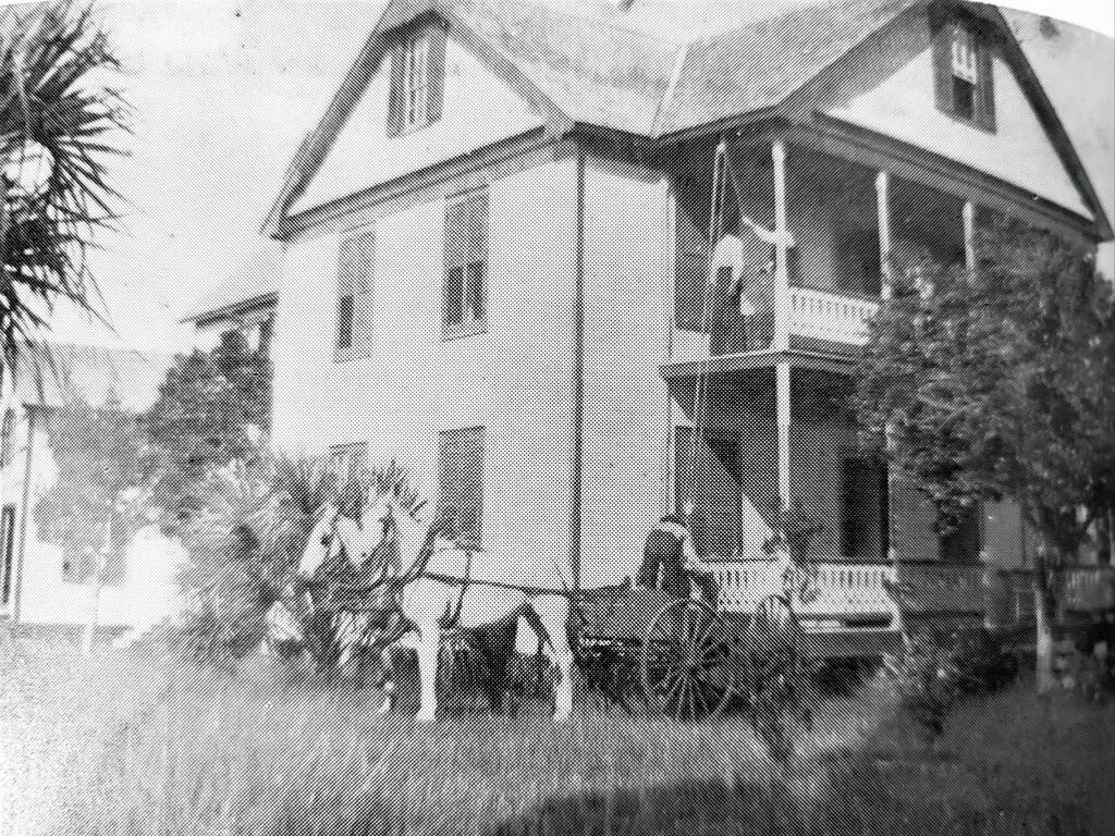 An old black and white photo of the Fogarty home shows a pulley moving trunks up to the second floor of the home.