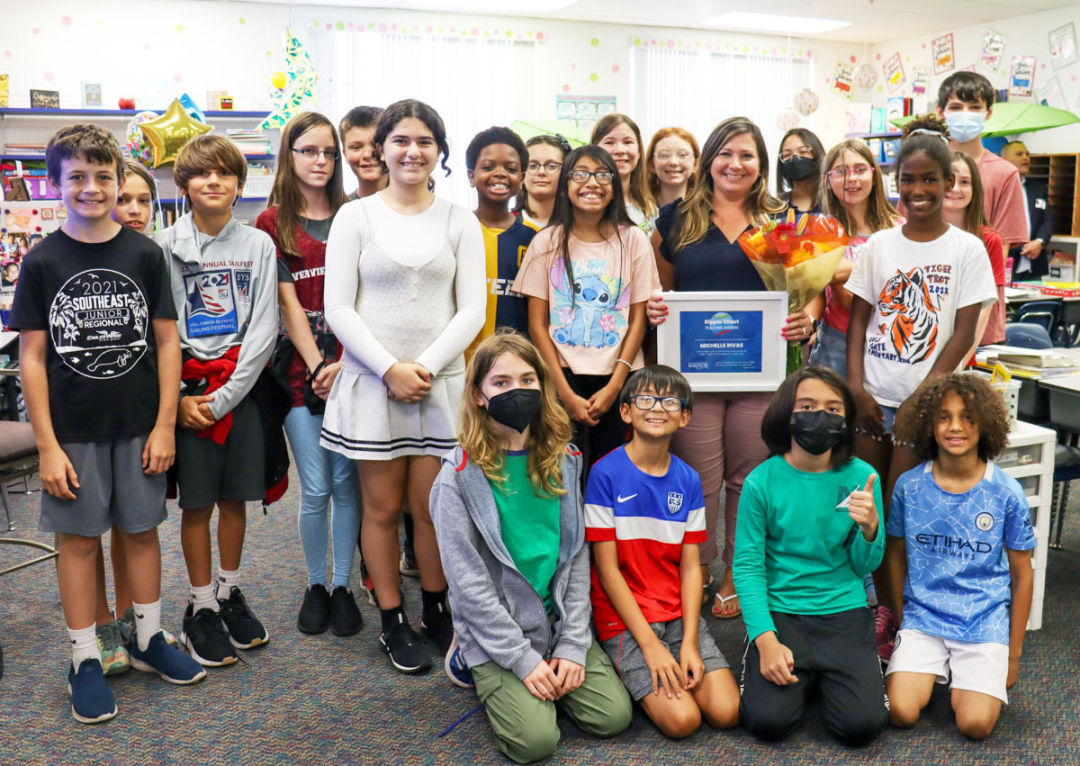 Gulf Gate Elementary teacher Michelle Rivas receives Barancik Foundation’s Ripple Effect award in front of her class.