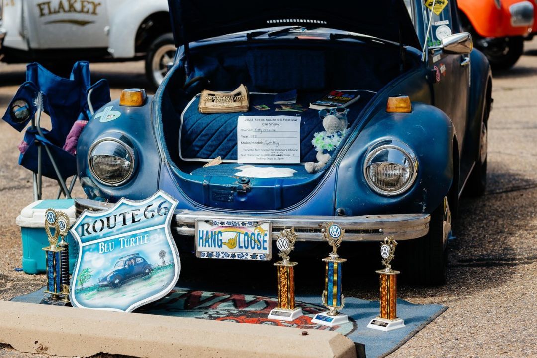 A Volkswagon Beetle displaying its many awards.