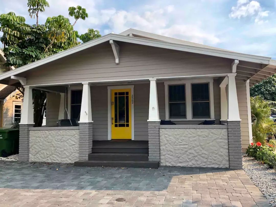 This historic home has a great front porch for people watching while relaxing on the hanging bench swing.