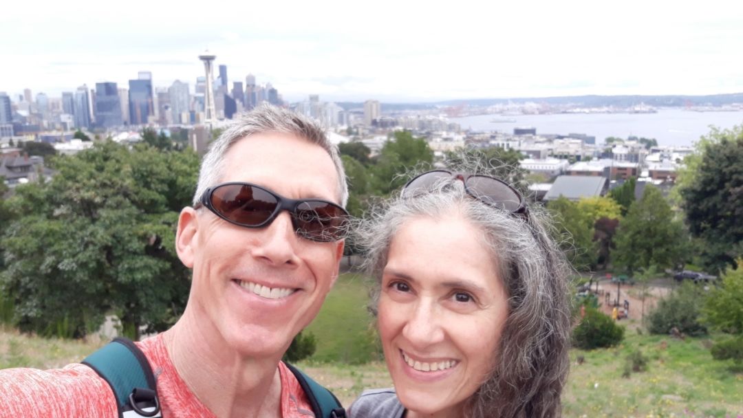 Robb and Claudia Mason take a selfie from Kerry Park with the Seattle skyline behind them.
