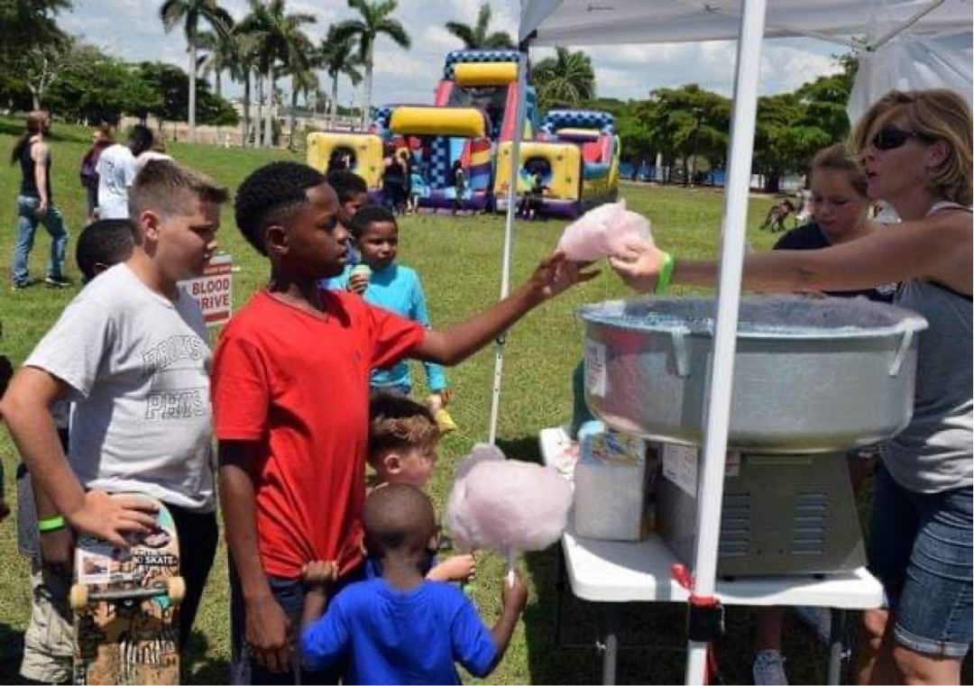 Kids line up for cotton candy at an outdoor family event at Payne Park in Sarasota