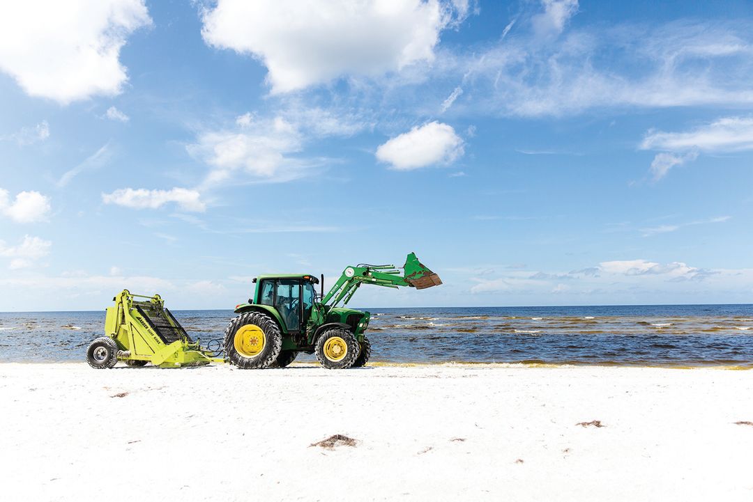 A county vessel collected dead fish on Lido Beach during the 2017 red tide outbreak.