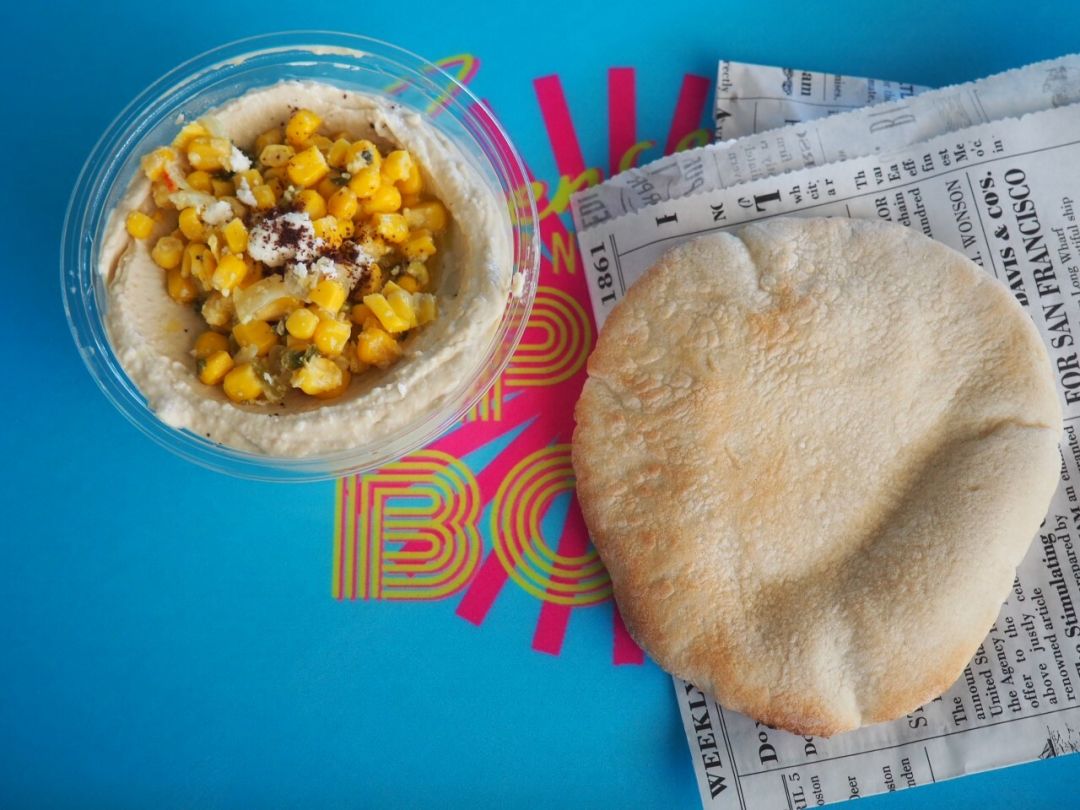 Hummus with sweet corn and pita.