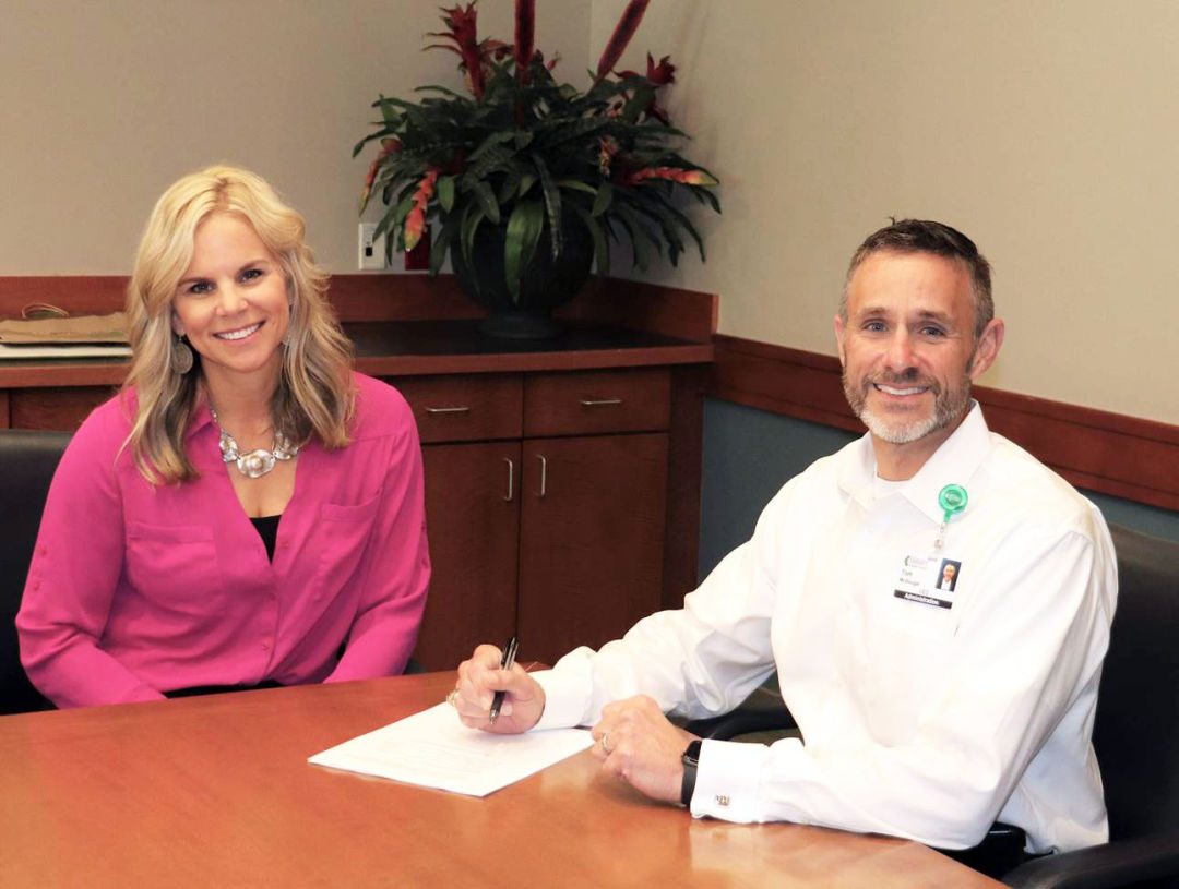 Kristi Hoskinson, VP of CareerEdge, and Tom McDougal, CEO, Manatee Memorial Hospital, signing grant agreement