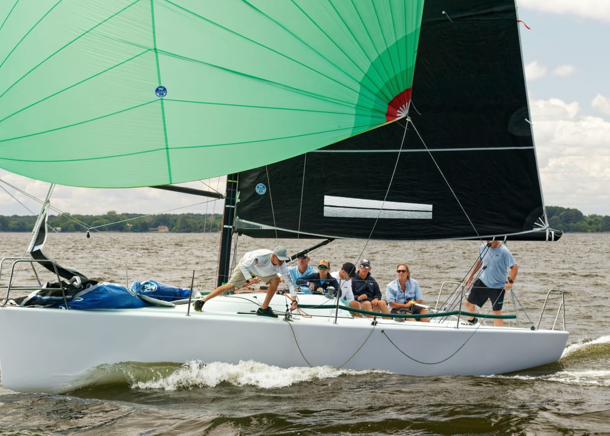 Adults taking a beginner sailing lesson