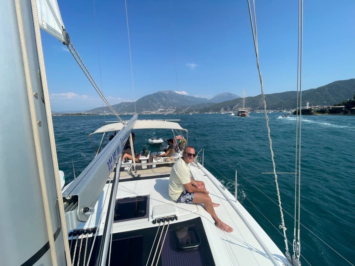 Sailing crew sitting on the deck of a yacht during a voyage at sea