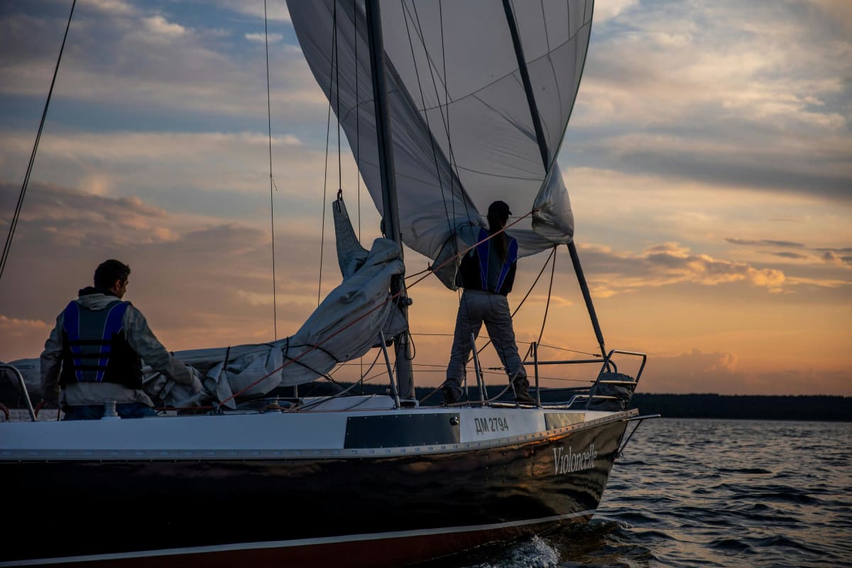 sailing crew enjoying sunset after learning points of sail