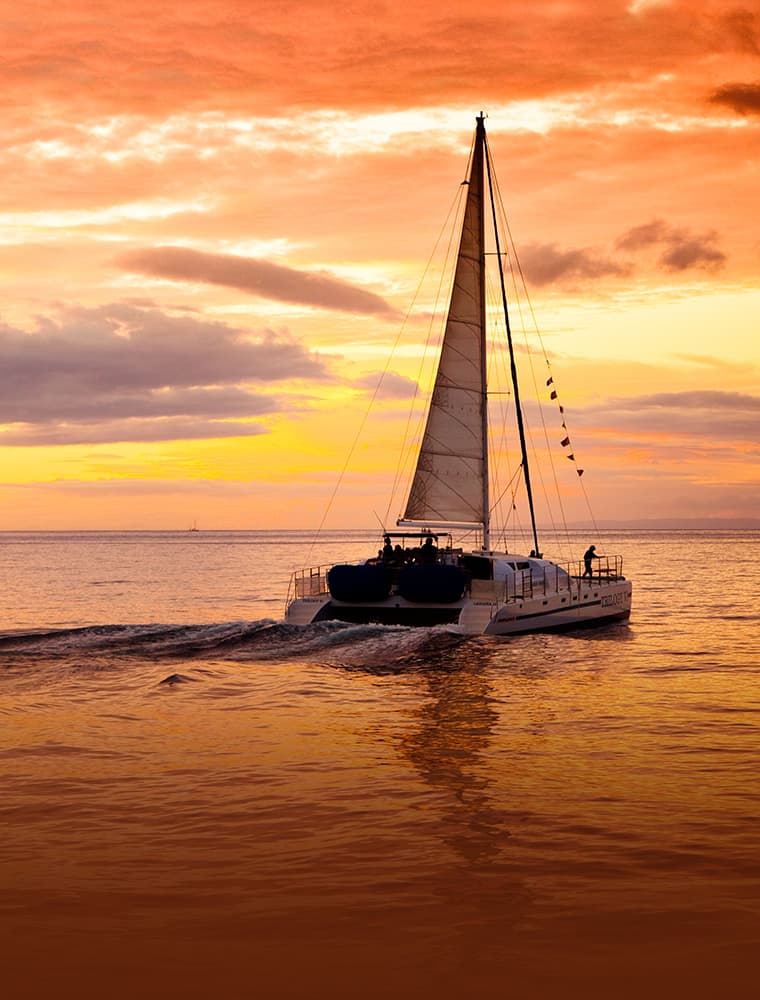 orange sunset with trilogy boat in foreground