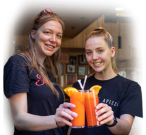 Two women celebrating with cocktails