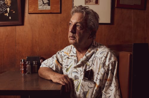 Robert Consiglio sitting in restaurant booth