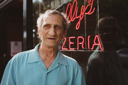 Sal standing outside Sally's Apizza restaurant