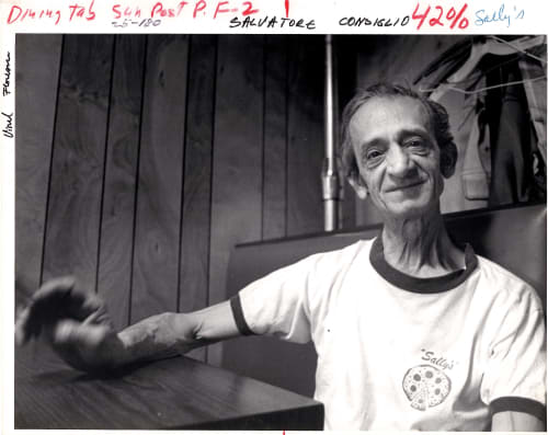 Sally sitting in restaurant booth