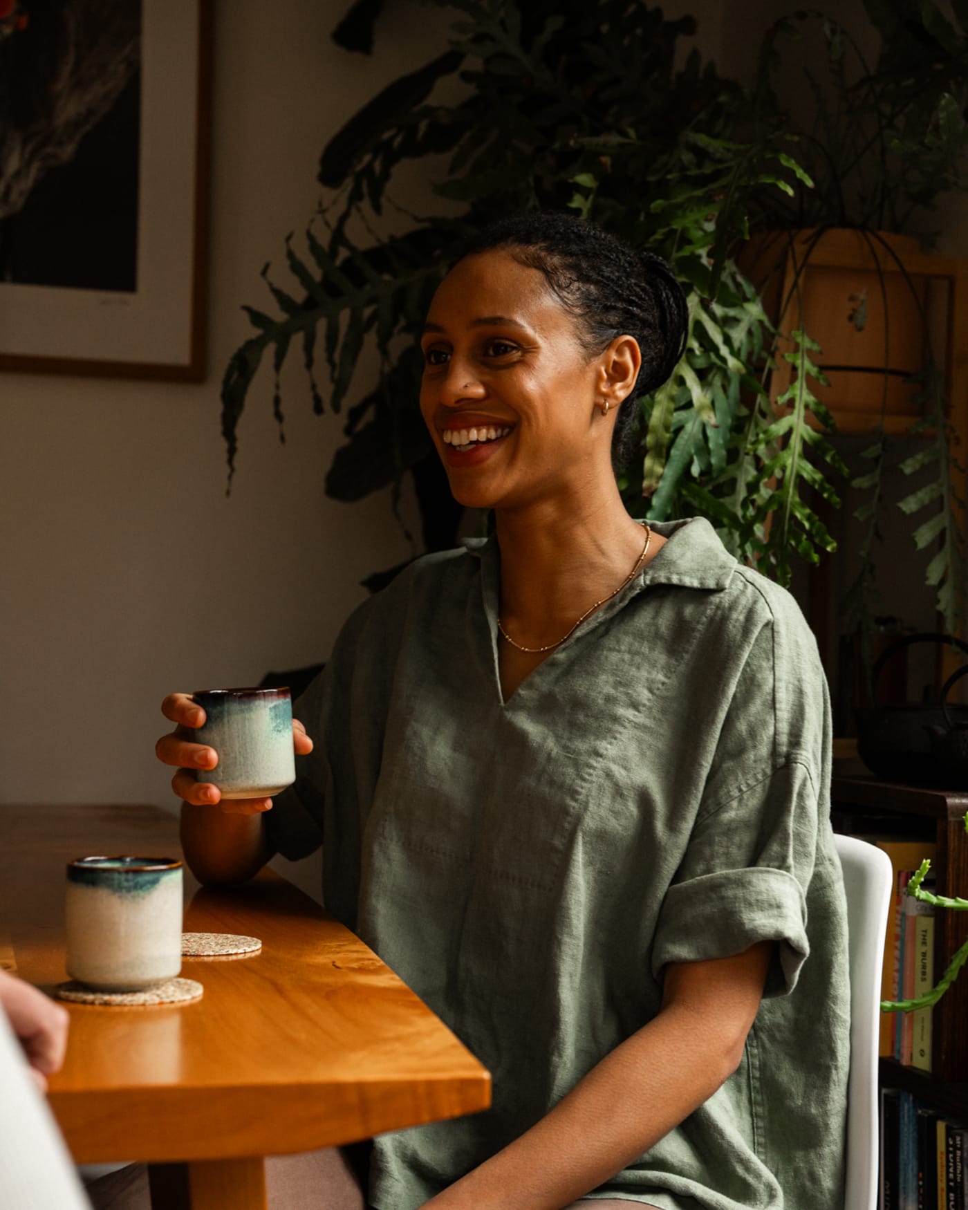 A person having a coffee and smiling.