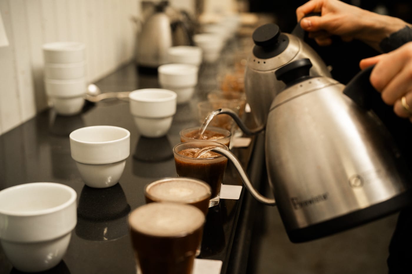 Quality control cupping detail of cups at Sample Coffee roastery.