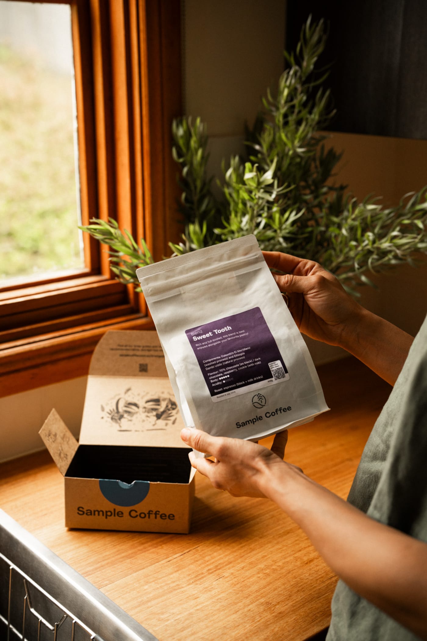 A bag of Sample Coffee beans and the delivery box.