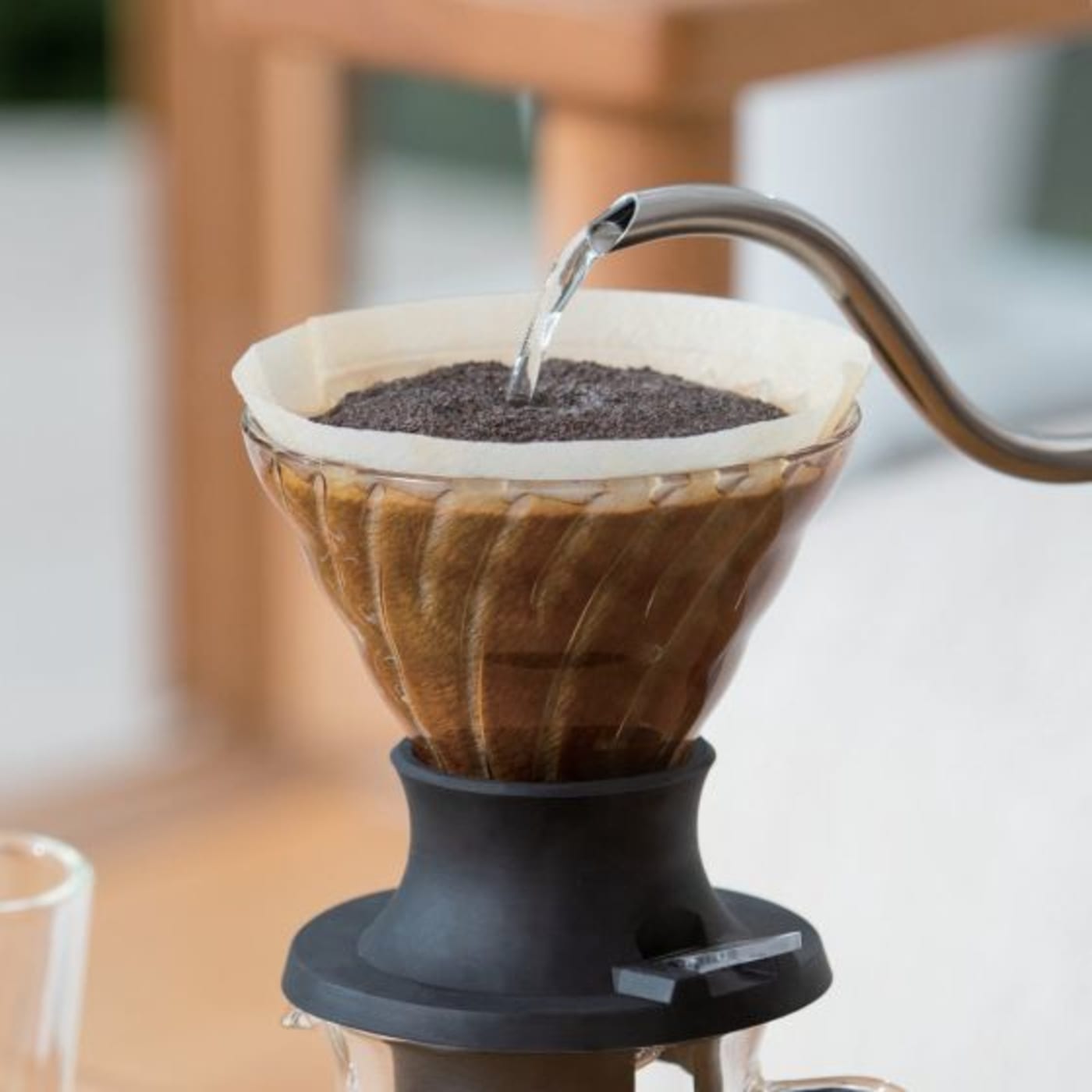 A Hario immersion dripper in use, pouring water.