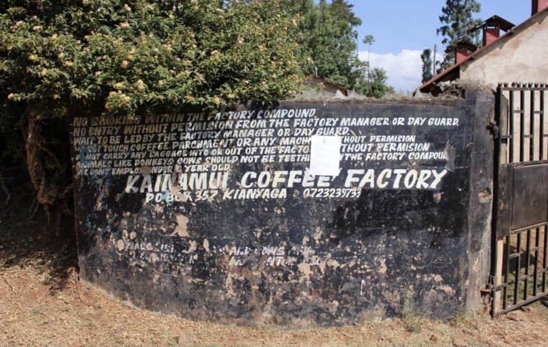 A word-based mural painted at the entry of the Kainamui Coffee Factory