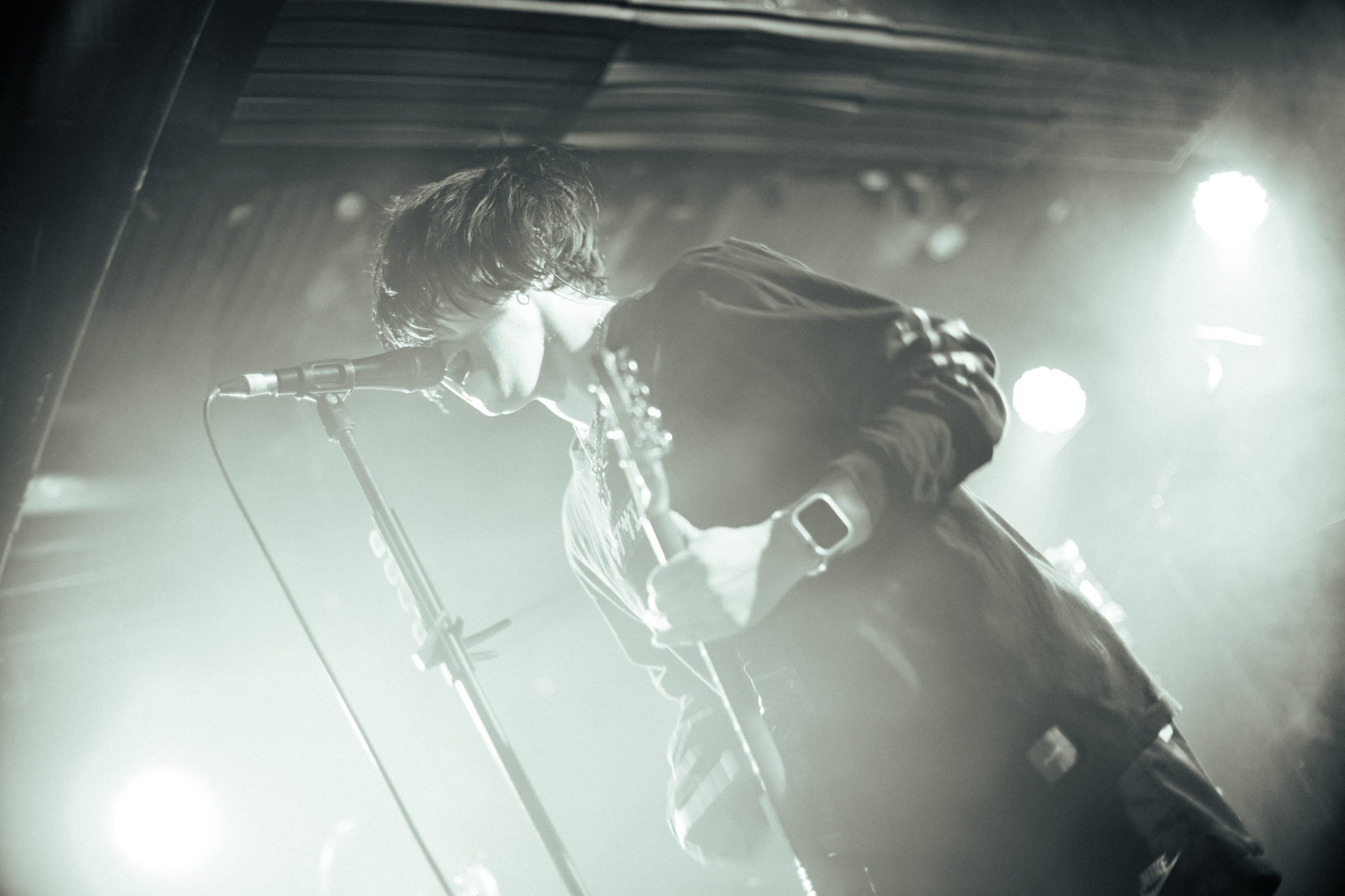 被光線灌滿鏡頭的畫面，雖然不是很清晰，但卻還是能隱約看出主唱Shinji賣力唱歌的畫面。