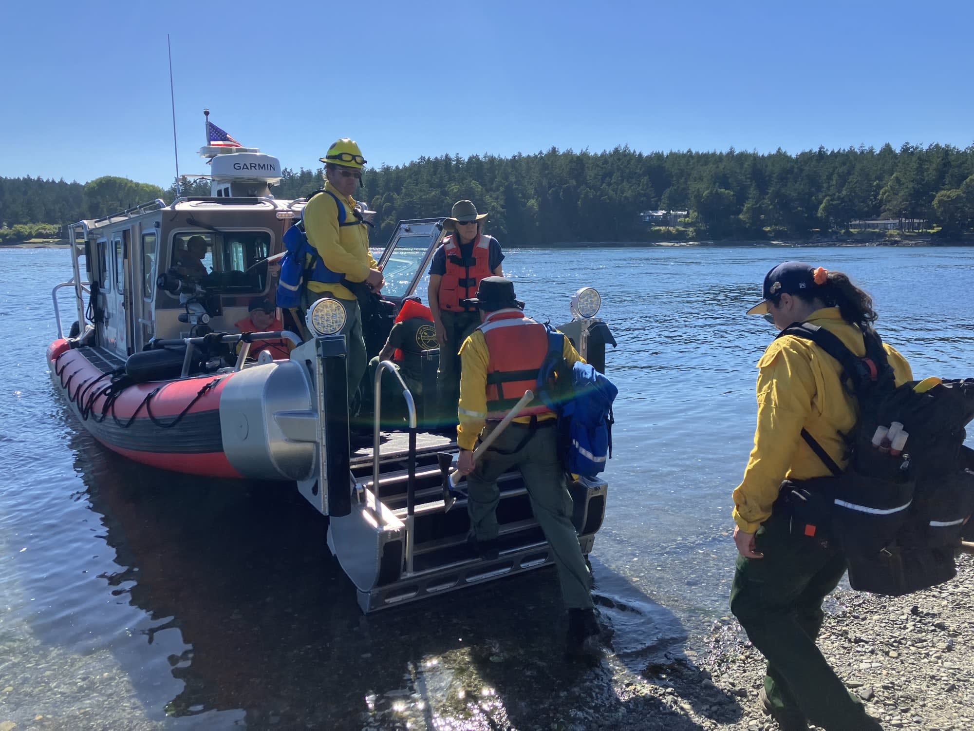SJIF&R boat picking up a wildland fire crew from the outer islands