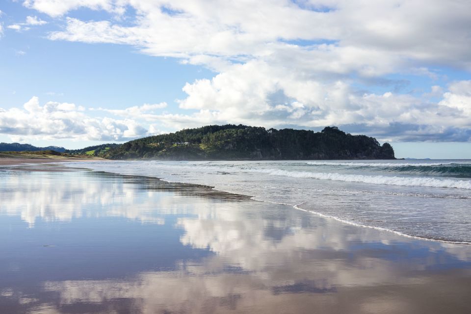 Water on the beach reflecting clouds